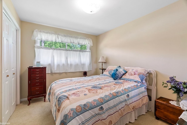 bedroom with light colored carpet and a closet