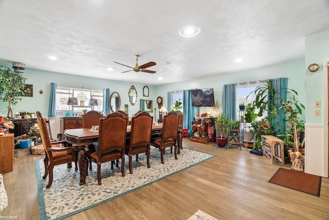 dining area with a textured ceiling, light hardwood / wood-style flooring, and ceiling fan