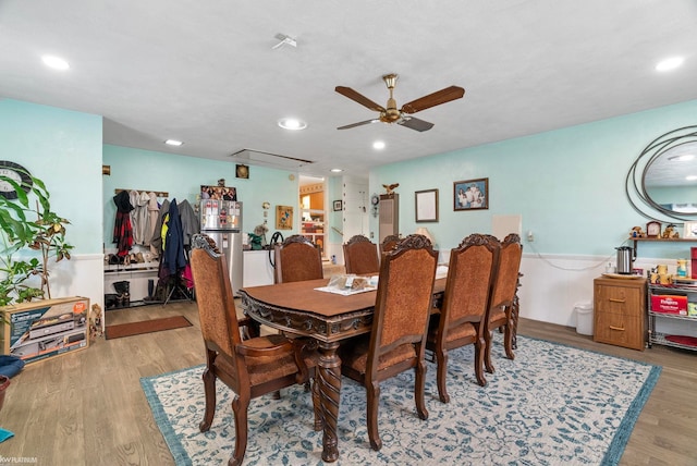 dining room with light hardwood / wood-style floors and ceiling fan