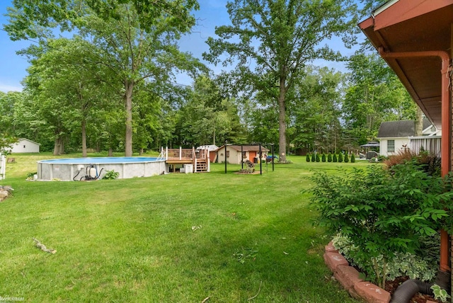 view of yard with a swimming pool side deck