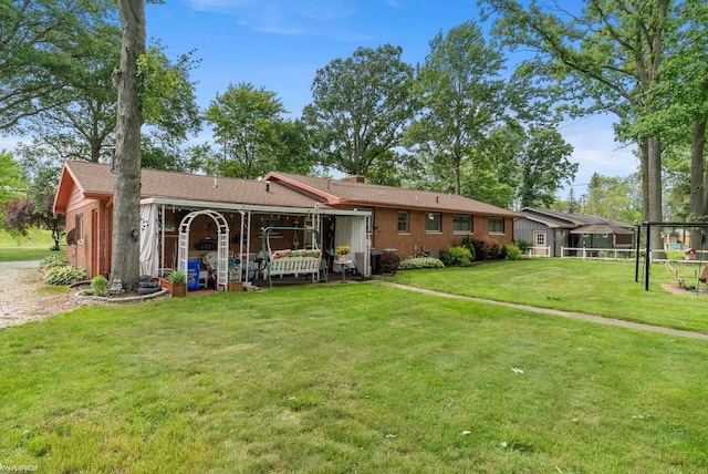 rear view of property featuring a yard