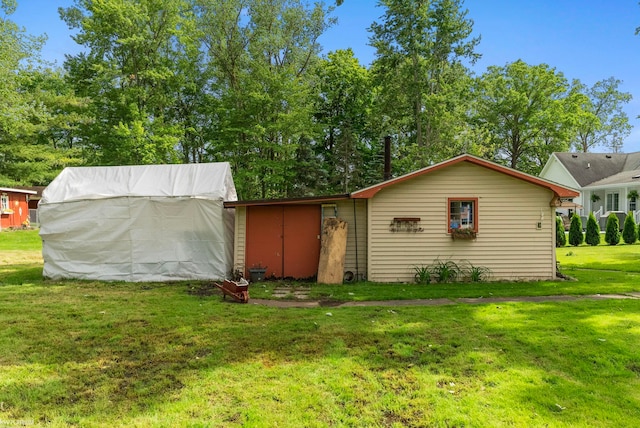 rear view of property featuring a yard