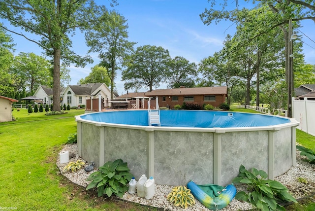 view of swimming pool with a lawn