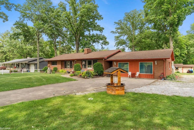 ranch-style home featuring a front yard