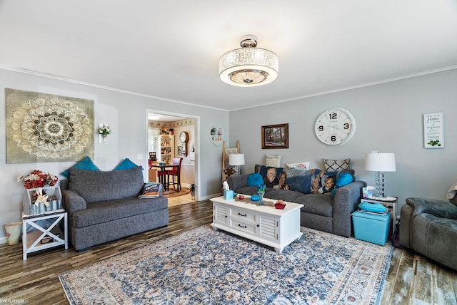 living room featuring ornamental molding and dark hardwood / wood-style flooring