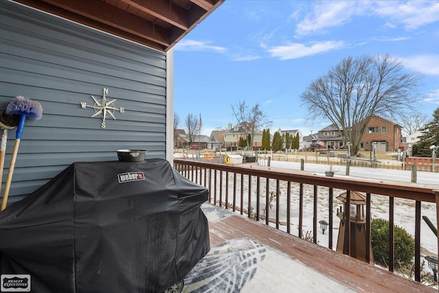 wooden terrace featuring a residential view and area for grilling