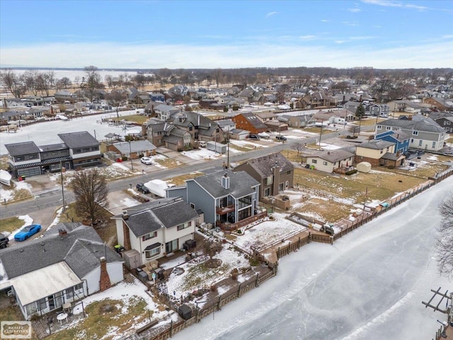 snowy aerial view with a residential view