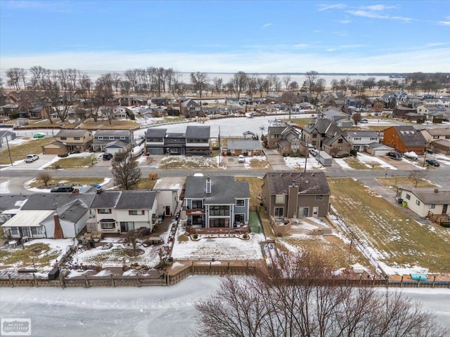 snowy aerial view featuring a residential view