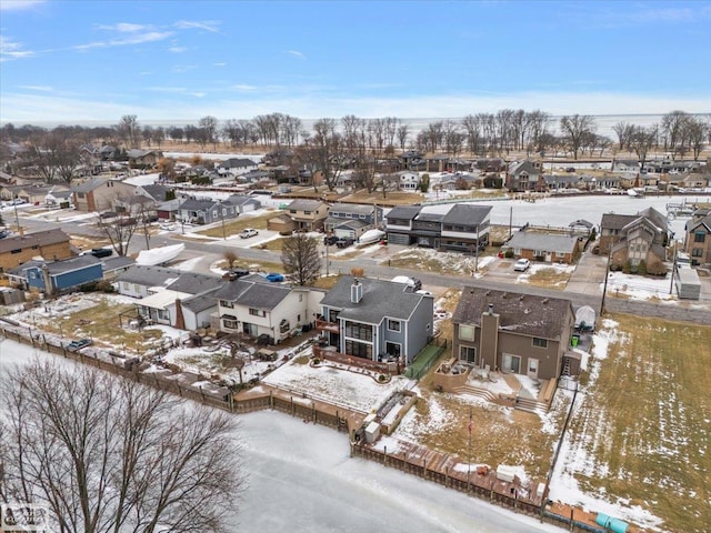 snowy aerial view with a residential view