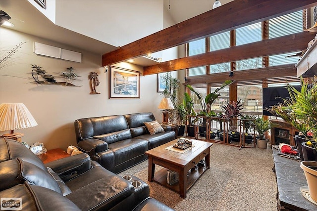 living area with beam ceiling and a high ceiling