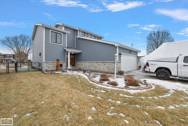 exterior space featuring fence, a yard, stone siding, an attached garage, and a gate