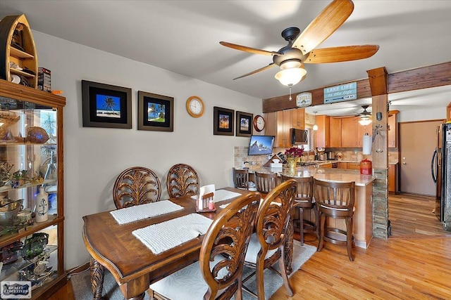 dining area featuring light wood finished floors and ceiling fan