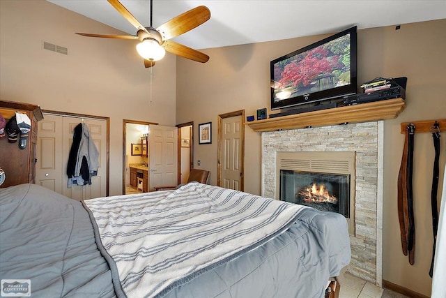 bedroom with visible vents, high vaulted ceiling, a stone fireplace, and ceiling fan