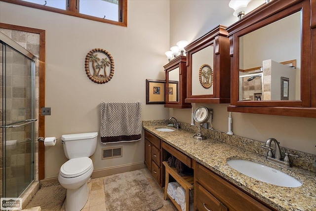 bathroom with a sink, visible vents, toilet, and a shower stall