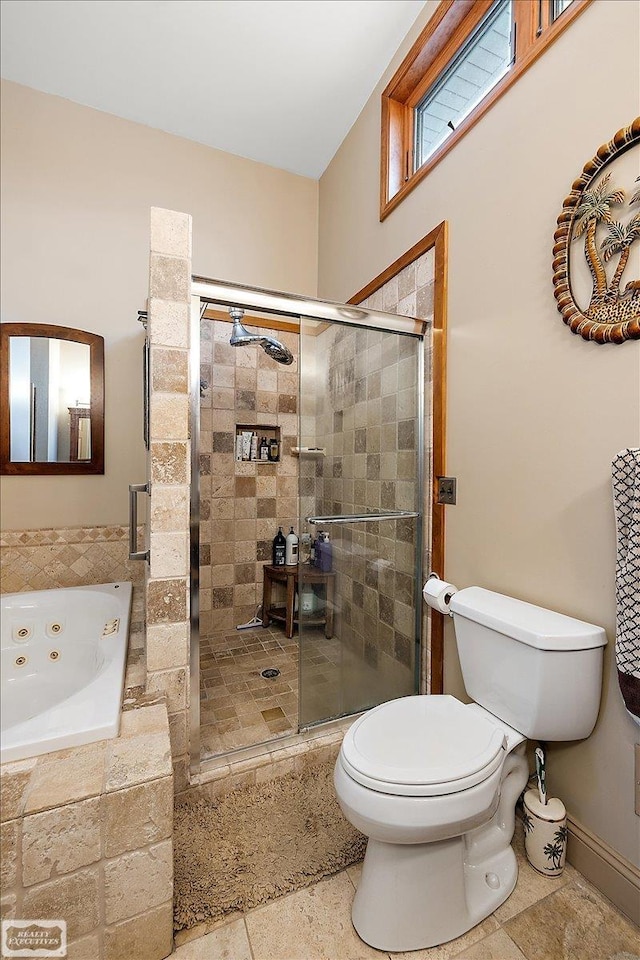 bathroom featuring toilet, a tub with jets, and a stall shower