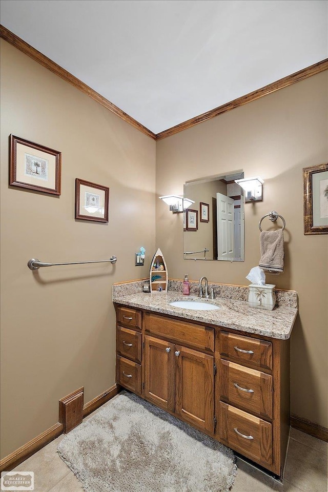 bathroom with baseboards, vanity, and crown molding