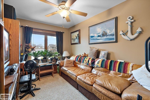 carpeted living room with a ceiling fan