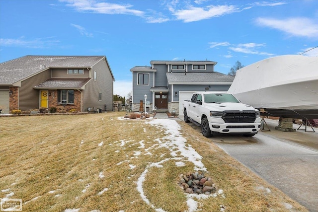 view of front of property with concrete driveway and a front yard