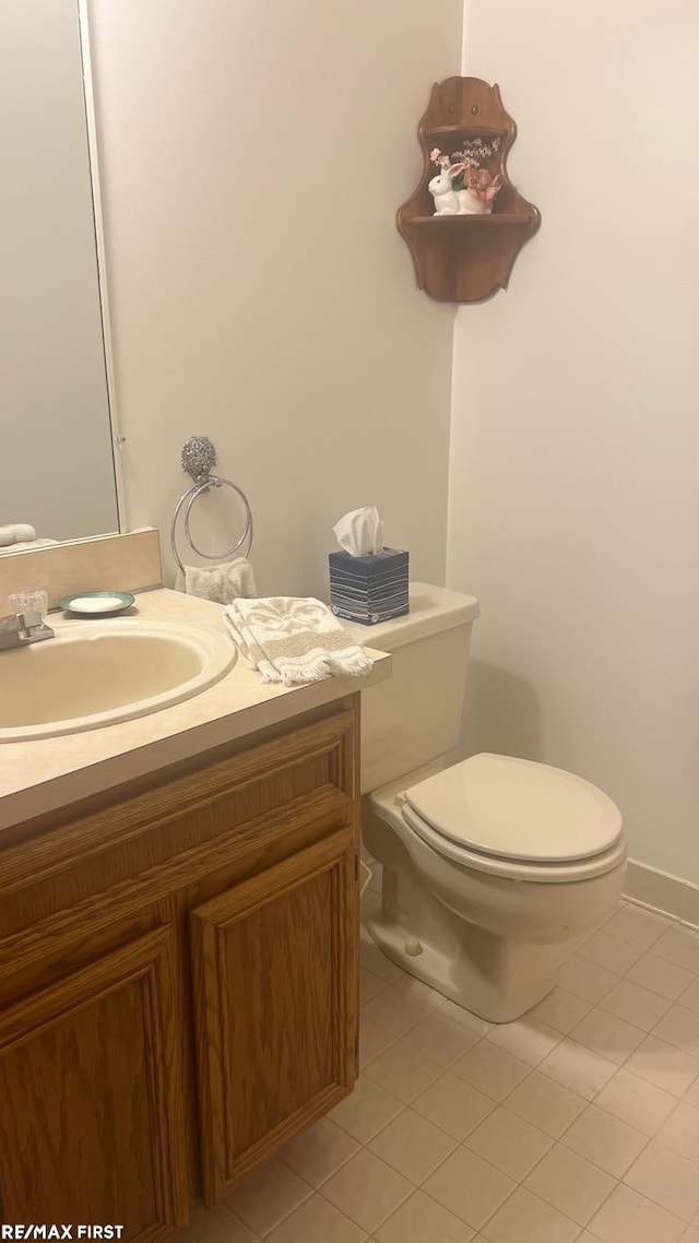 bathroom with vanity, tile patterned flooring, and toilet