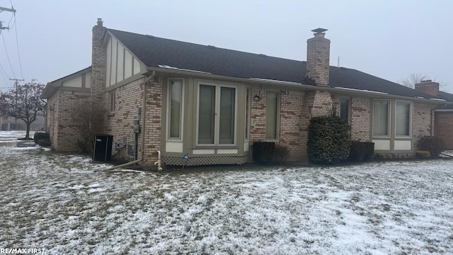 view of snow covered rear of property