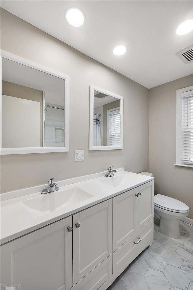 bathroom featuring vanity and toilet