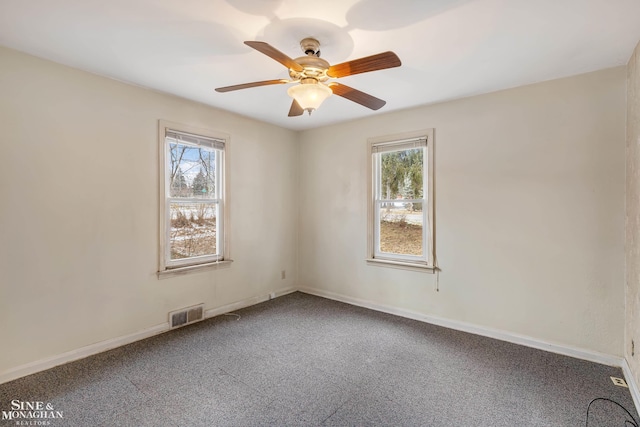 carpeted spare room featuring ceiling fan