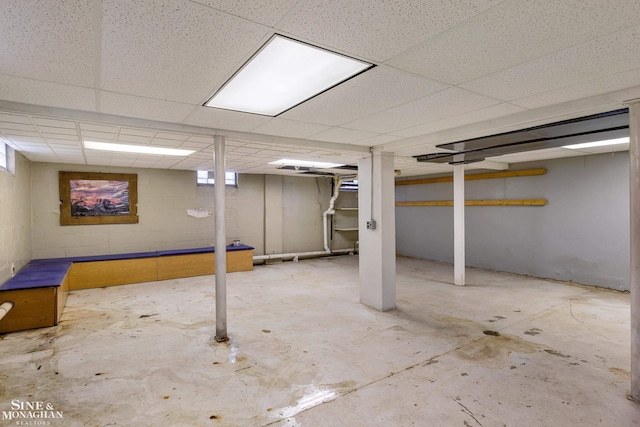 basement with a paneled ceiling