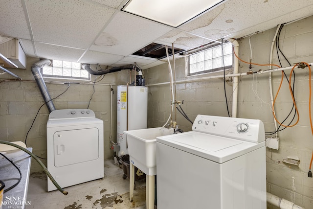 laundry room with water heater, separate washer and dryer, and sink