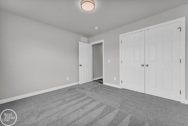 unfurnished bedroom featuring carpet floors and a closet