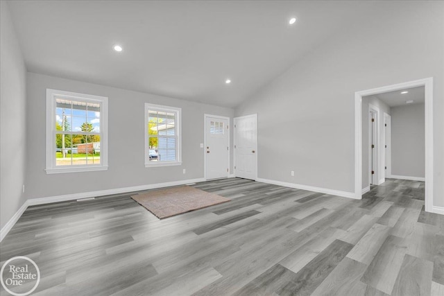 interior space featuring high vaulted ceiling and light hardwood / wood-style floors