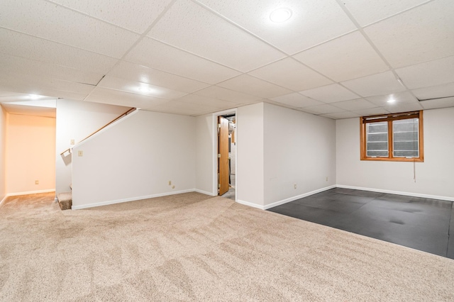 basement featuring carpet floors and a drop ceiling