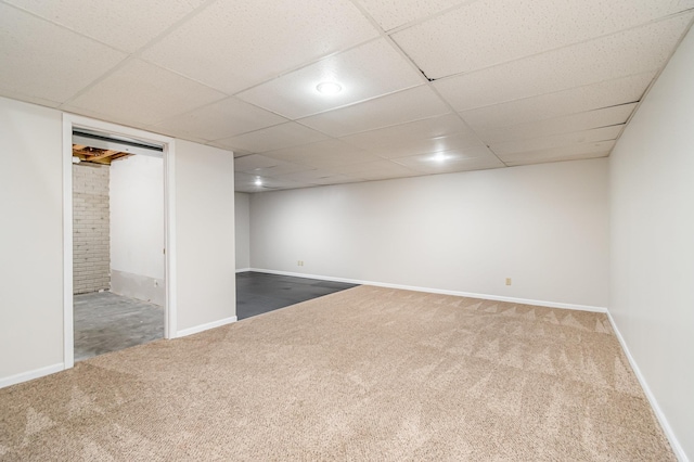 basement with carpet flooring and a drop ceiling