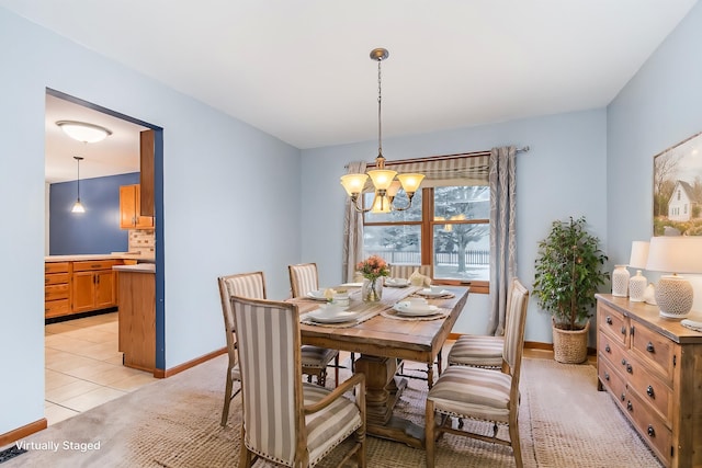 dining space with a chandelier and light tile patterned floors