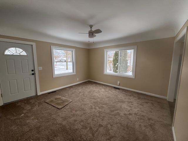 carpeted entrance foyer with ceiling fan