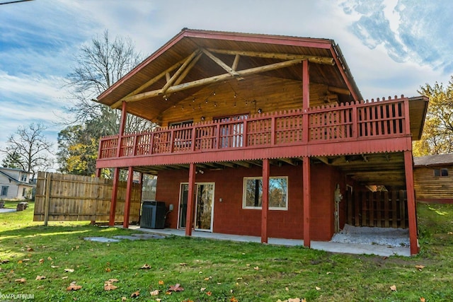 back of house featuring central AC, a lawn, and a deck