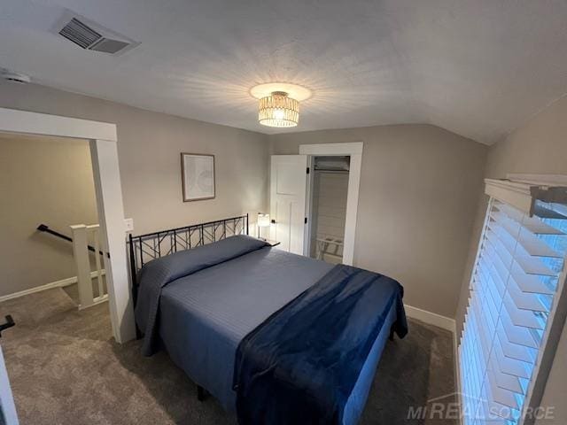 carpeted bedroom with vaulted ceiling