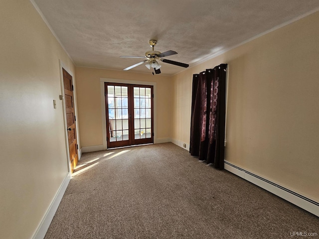 carpeted empty room with a baseboard radiator, a textured ceiling, crown molding, and french doors