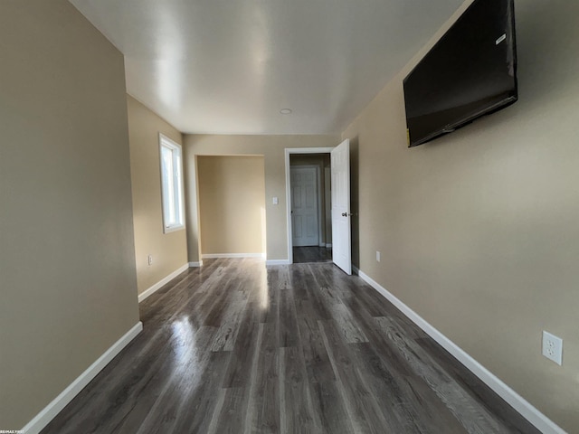 unfurnished room featuring dark wood-type flooring