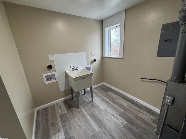 clothes washing area with hardwood / wood-style flooring, washer hookup, and electric panel