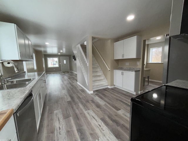 kitchen with sink, light hardwood / wood-style floors, white cabinets, and appliances with stainless steel finishes