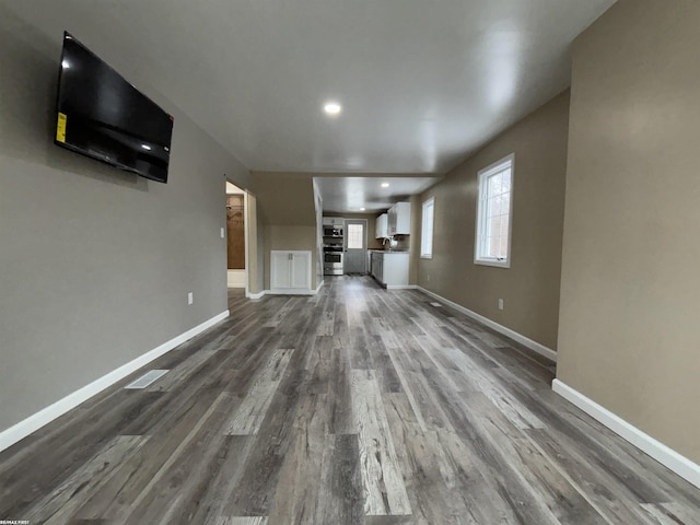 unfurnished living room featuring dark hardwood / wood-style floors