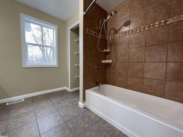 bathroom featuring tile patterned floors and tiled shower / bath