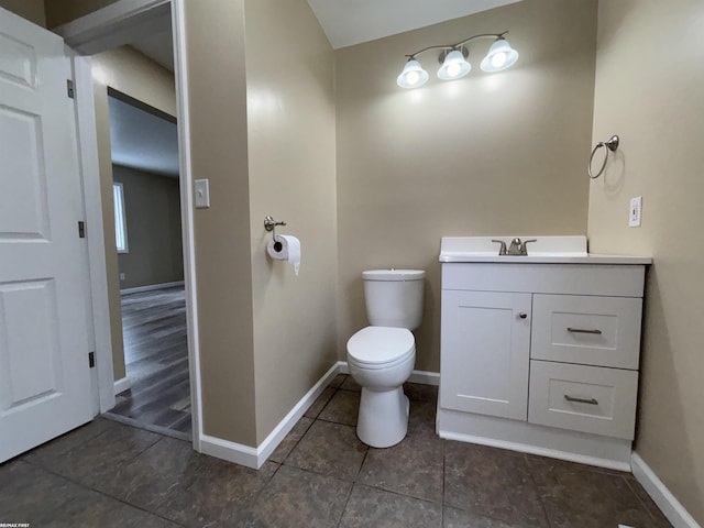 bathroom featuring vanity, toilet, and tile patterned flooring