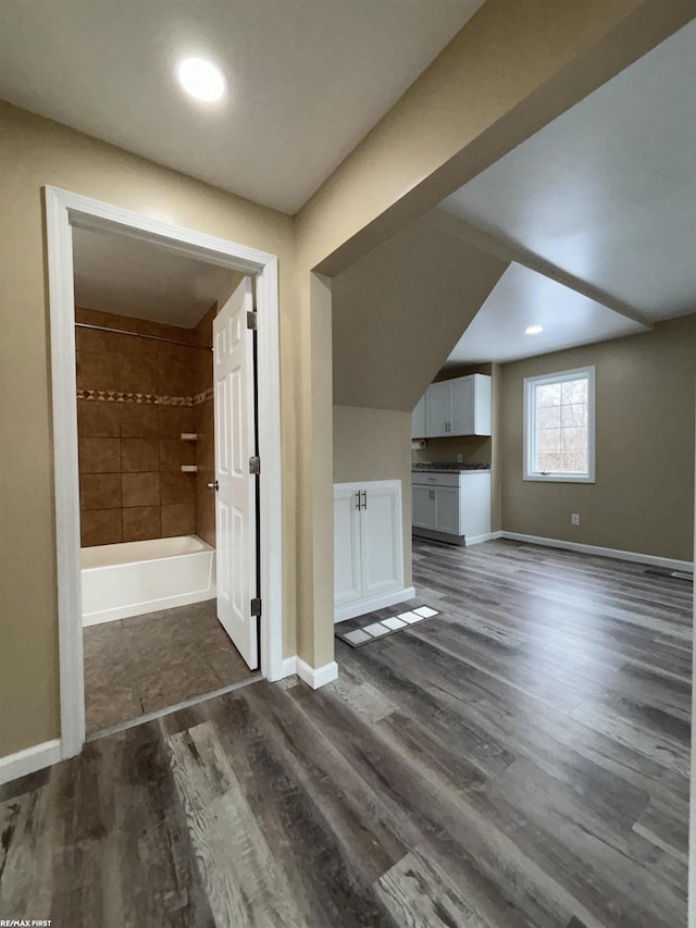 additional living space with dark hardwood / wood-style floors