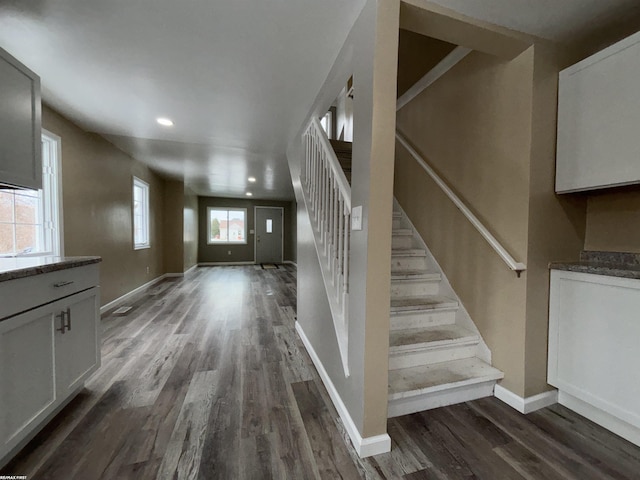 stairs with hardwood / wood-style floors