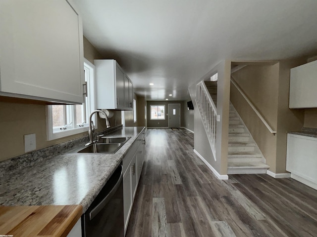kitchen with white cabinetry, sink, dark wood-type flooring, and black dishwasher