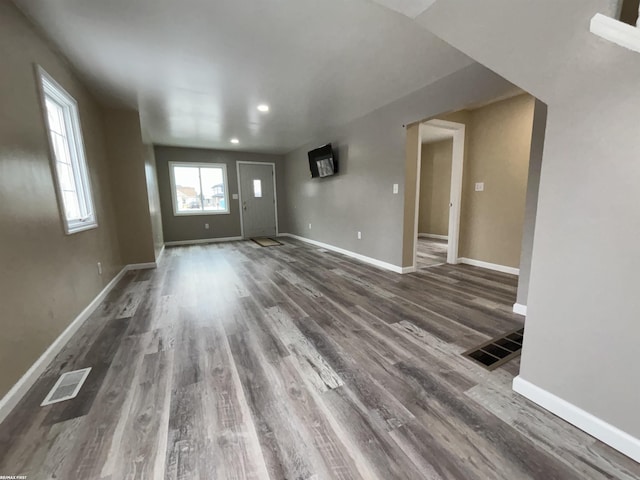 unfurnished living room featuring dark hardwood / wood-style floors