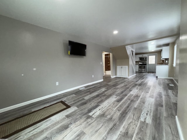 unfurnished living room with hardwood / wood-style flooring