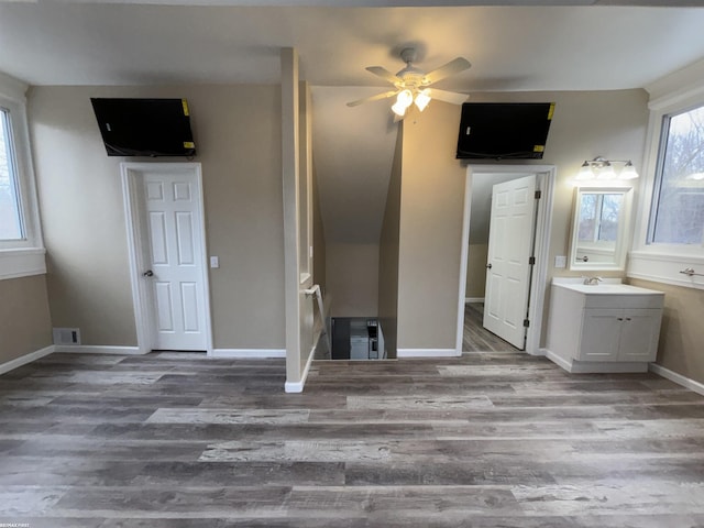 unfurnished bedroom featuring hardwood / wood-style floors and sink