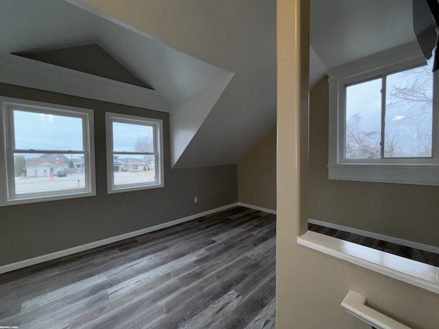 bonus room featuring lofted ceiling and dark wood-type flooring